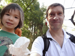 Tim with a Parrot on his shoulder and Max in an Aviary at Zoo Veldhoven