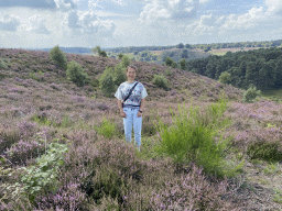 Miaomiao with trees and purple heather near the top of the Posbank hill