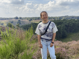 Miaomiao with trees and purple heather near the top of the Posbank hill