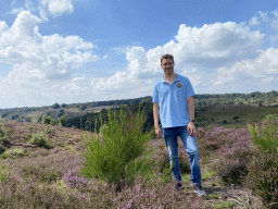 Tim with trees and purple heather near the top of the Posbank hill