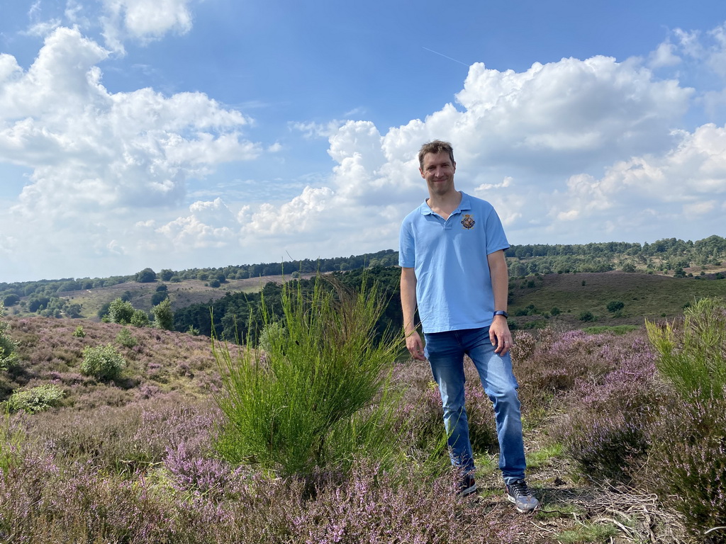 Tim with trees and purple heather near the top of the Posbank hill