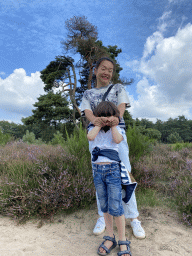 Miaomiao and Max with a tree and purple heather on the north side of the Posbank hill