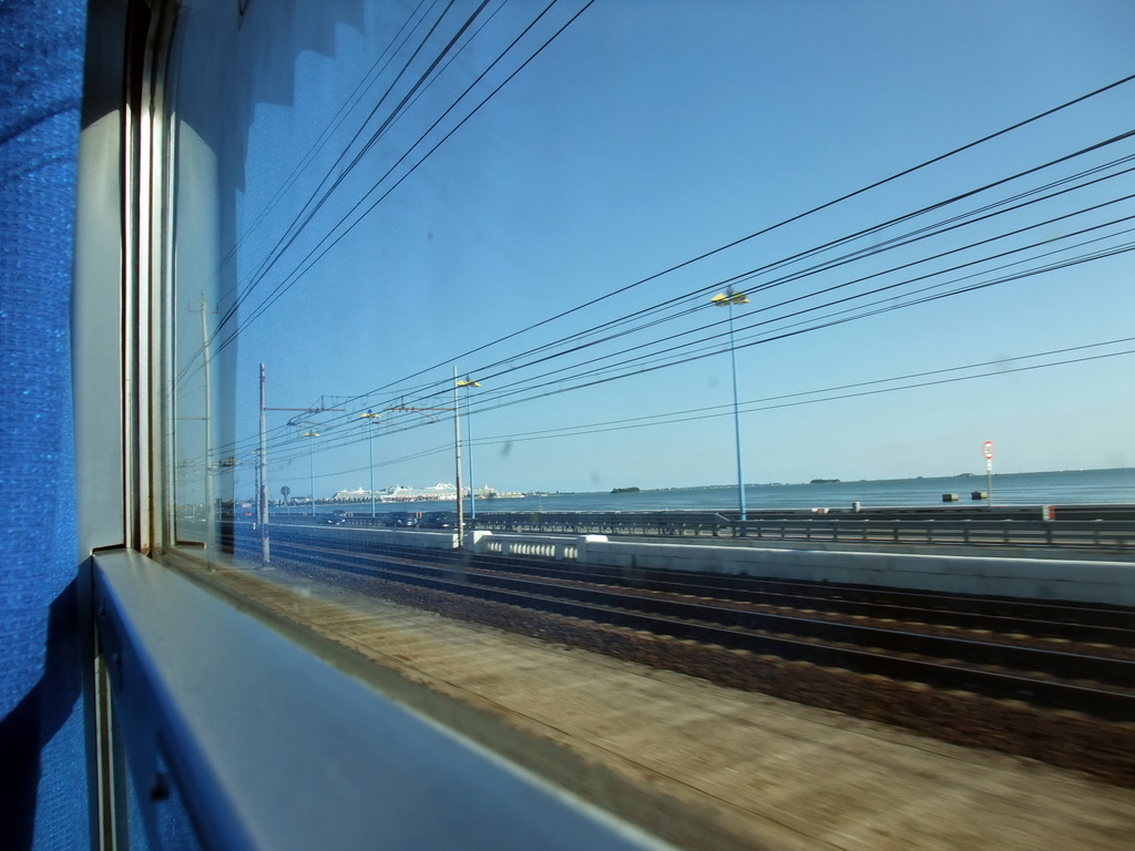 View on the Ponte della Libertà bridge and boats at the Bacino Stazione Marittima harbor from the train from Mestre to Venice