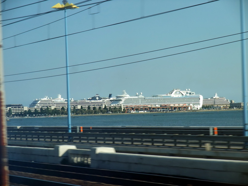 View on the Ponte della Libertà bridge and boats at the Bacino Stazione Marittima harbor from the train from Mestre to Venice