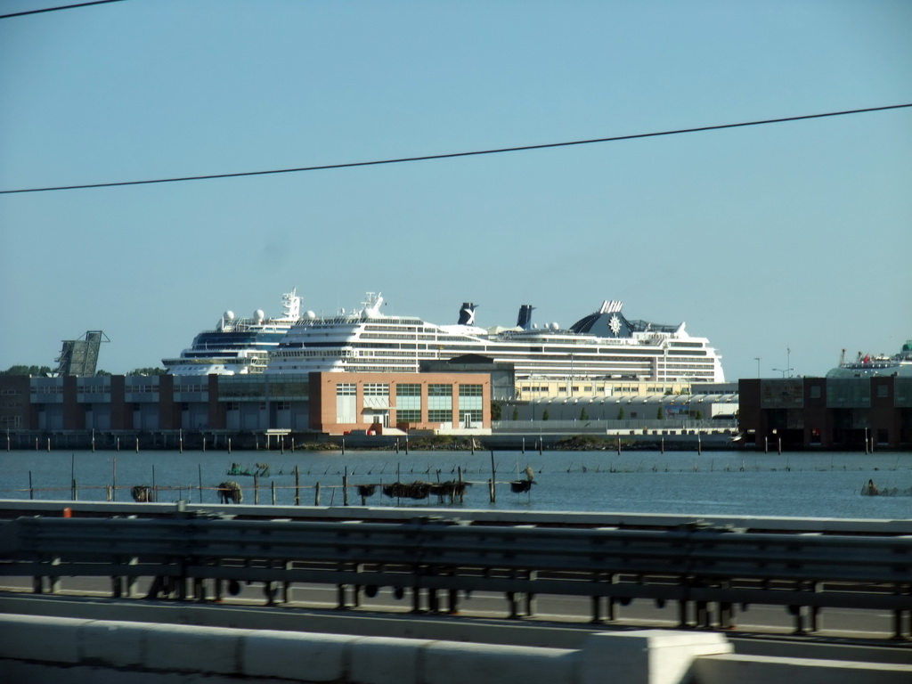 View on the Ponte della Libertà bridge and boats at the Bacino Stazione Marittima harbor from the train from Mestre to Venice