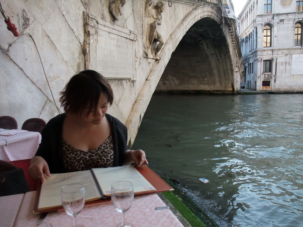 Miaomiao having dinner at the Al Buso restaurant under the Ponte di Rialto bridge over the Canal Grande