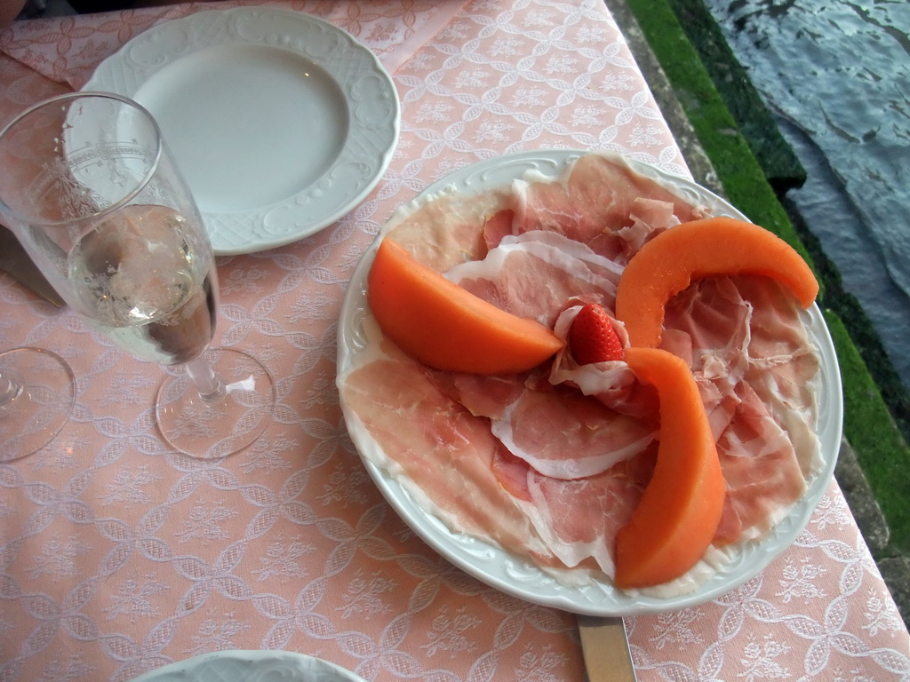 Ham, melon and strawberry at the Al Buso restaurant under the Ponte di Rialto bridge over the Canal Grande