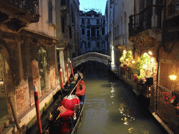 Gondolas and a small bridge over the Rio dei Bareteri canal, viewed from the Ponte dei Bareteri bridge, at sunset