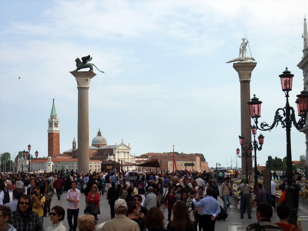 The Piazzetta San Marco square with the columns with the sculptures `Lion of Venice` and `Saint Theodore` on top, and the San Giorgio Maggiore island with the Basilica di San Giorgio Maggiore church