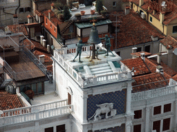 Bell and statues on top of the Clock Tower, viewed from the Campanile Tower of the Basilica di San Marco church