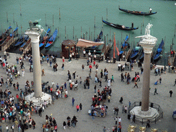 The columns with the sculptures `Lion of Venice` and `Saint Theodore` on top at the Piazzetta San Marco square, viewed from the Campanile Tower of the Basilica di San Marco church