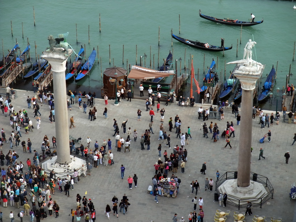 The columns with the sculptures `Lion of Venice` and `Saint Theodore` on top at the Piazzetta San Marco square, viewed from the Campanile Tower of the Basilica di San Marco church