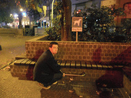 Tim with `Dog Park` sign at a square in Mestre, by night