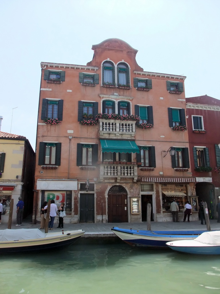 Boats in the Rio dei Vetrai river and a building at the Fondamenta Daniele Manin street at the Murano islands