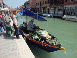 Boat with vegetables and the Ponte Ballarin bridge over the Rio dei Vetrai river at the Murano islands