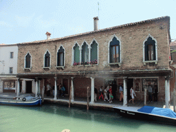 Boats in the Rio dei Vetrai river and a building at the Fondamenta Daniele Manin street at the Murano islands