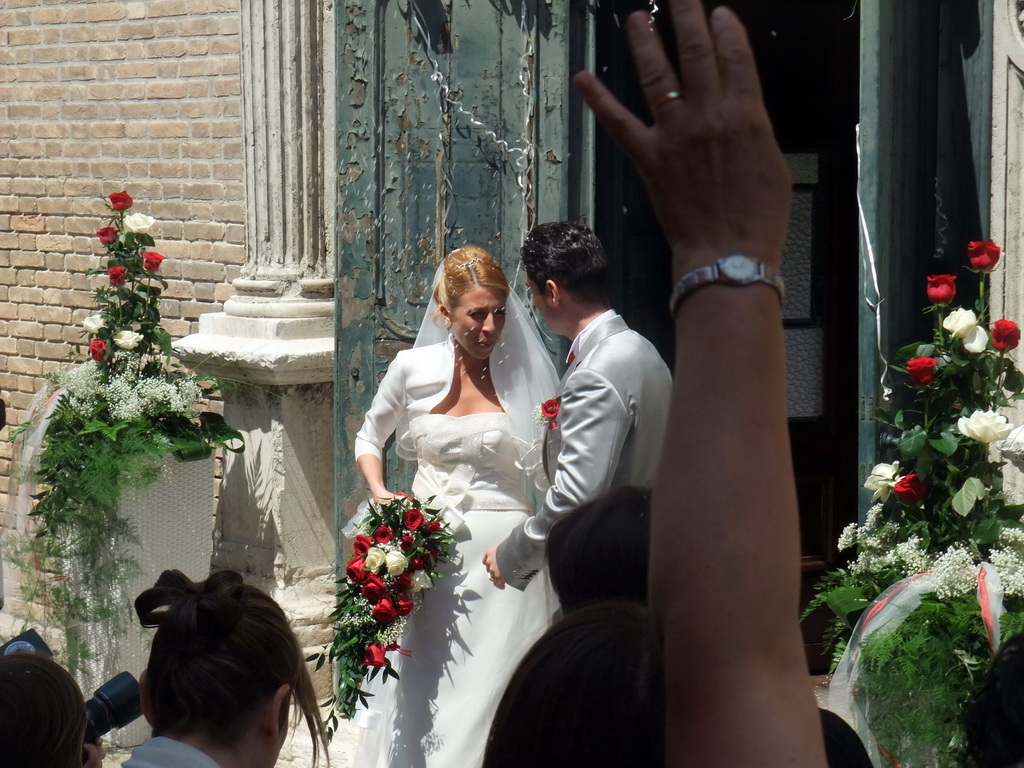 People throwing rice at a married couple in front of the Chiesa di San Pietro Martire church at the Murano islands