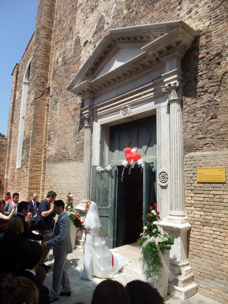 Married couple in front of the Chiesa di San Pietro Martire church at the Murano islands