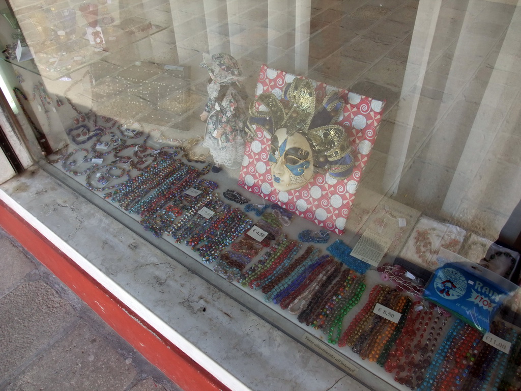 Glass items, doll and mask in the window of the shop of Mr. Simioni at the Fondamenta Andrea Navagero street