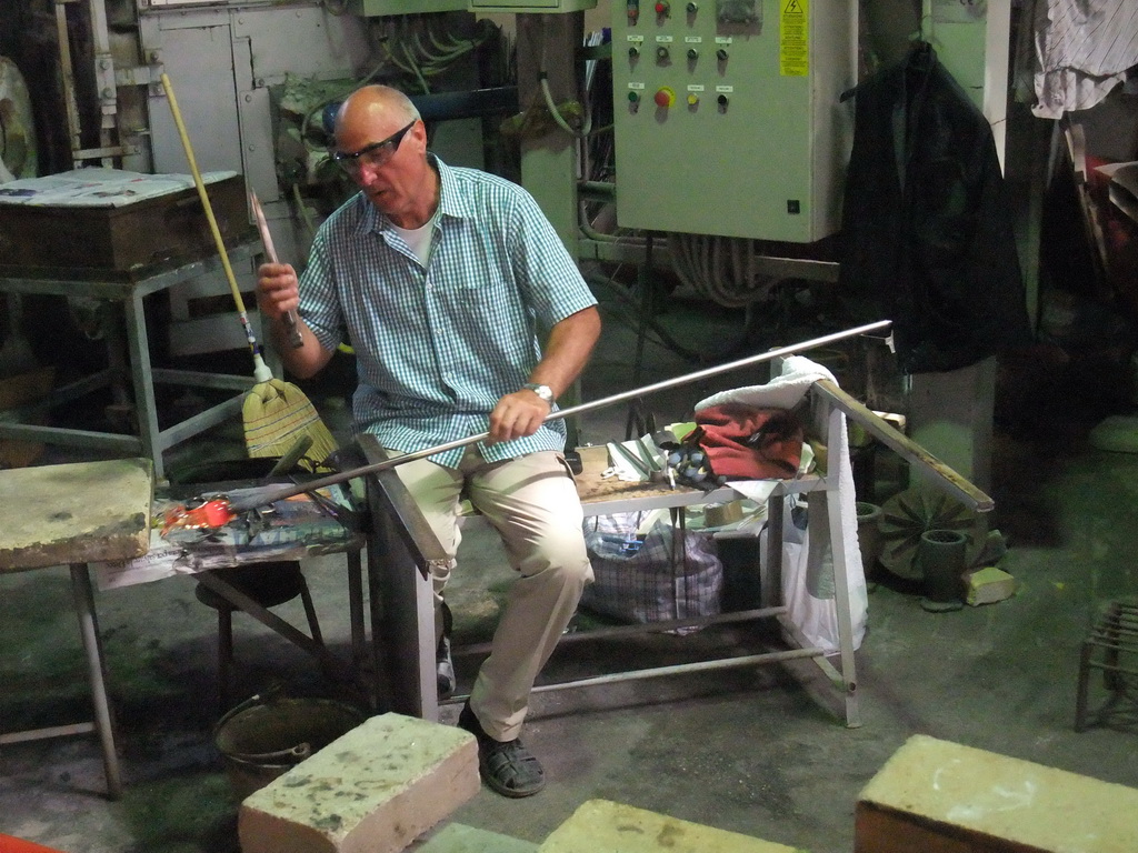 Man making glass figure in the workplace of the shop of Mr. Simioni at the Fondamenta Andrea Navagero street at the Murano islands