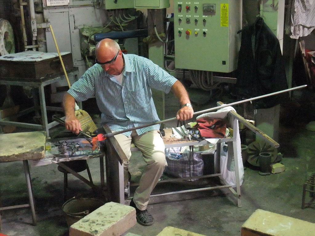 Man making glass figure in the workplace of the shop of Mr. Simioni at the Fondamenta Andrea Navagero street at the Murano islands