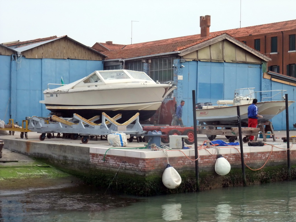 Boats at the dock at the west side of the Murano islands, viewed from the ferry from Murano