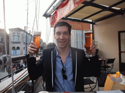 Tim with two Pedavena beers at the roof terrace of a restaurant at the Strada Nuova street