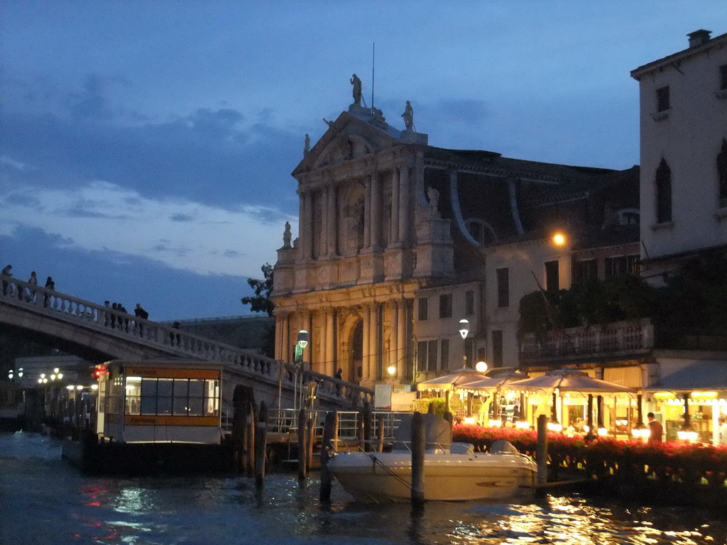 The Ponte degli Scalzi bridge over the Canal Grande and the Chiesa di Santa Maria di Nazareth church, viewed from the Canal Grande ferry, at sunset