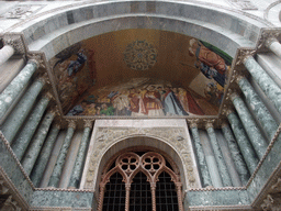 Paintings and reliefs at the center right portal at the front of the Basilica di San Marco church