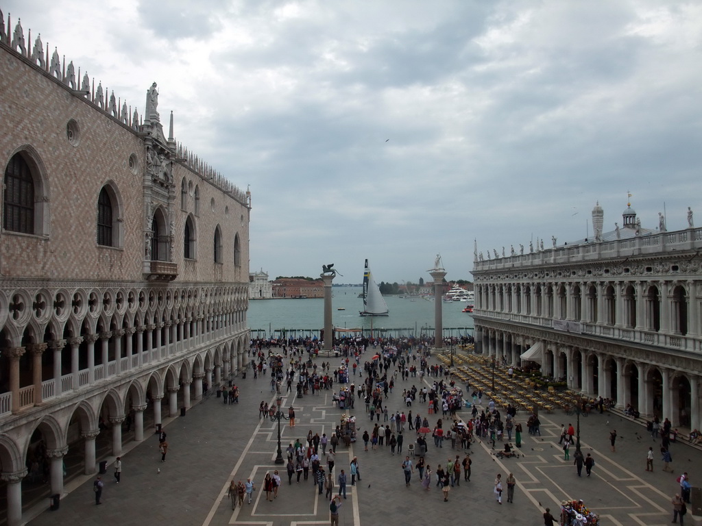 The Piazzetta San Marco square with the Palazzo Ducale palace, the Biblioteca Marciana library and the columns with the sculptures `Lion of Venice` and `Saint Theodore` on top, and a sailing boat of the America`s Cup sailing race in the Bacino di San Marco basin, viewed from the loggia of the Basilica di San Marco church