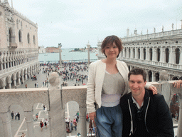 Tim and Miaomiao at the loggia of the Basilica di San Marco church, with a view on the Piazzetta San Marco square with the Palazzo Ducale palace, the Biblioteca Marciana library and the columns with the sculptures `Lion of Venice` and `Saint Theodore` on top, and the Bacino di San Marco basin