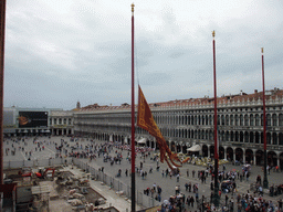 Venetian, Italian and European flags and the Piazza San Marco square with the Napoleonic Wing of the Procuraties building and the Procuratie Vecchie building, viewed from the loggia of the Basilica di San Marco church
