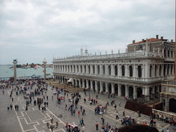 The Piazzetta San Marco square with the Biblioteca Marciana library and the columns with the sculptures `Lion of Venice` and `Saint Theodore` on top, and the Bacino di San Marco basin, viewed from the loggia of the Basilica di San Marco church