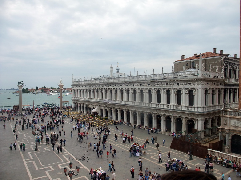 The Piazzetta San Marco square with the Biblioteca Marciana library and the columns with the sculptures `Lion of Venice` and `Saint Theodore` on top, and the Bacino di San Marco basin, viewed from the loggia of the Basilica di San Marco church