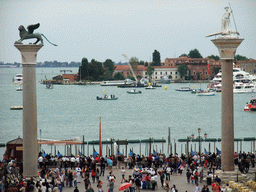 The columns with the sculptures `Lion of Venice` and `Saint Theodore` on top at the Piazzetta San Marco square, the Giudecca island and the Bacino di San Marco basin, viewed from the loggia of the Basilica di San Marco church