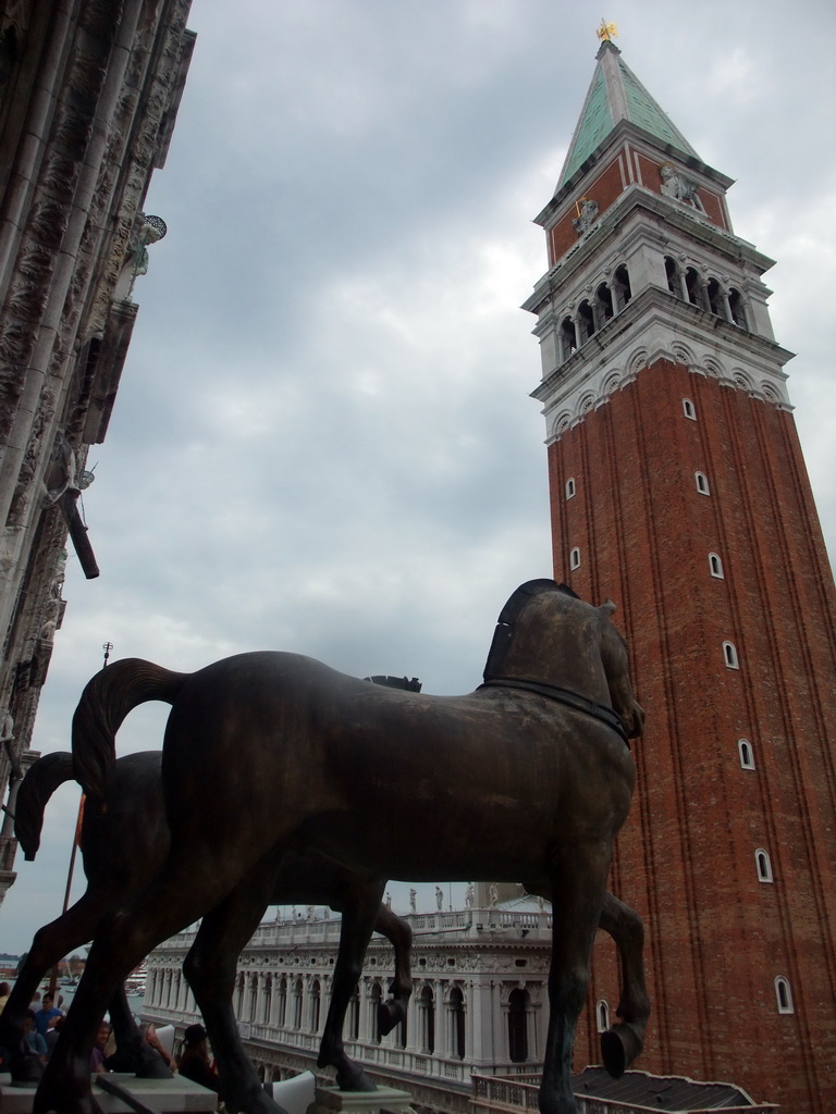 The loggia of the Basilica di San Marco church with the replica Horses of Saint Mark statues, with a view on the Campanile Tower and the Biblioteca Marciana library