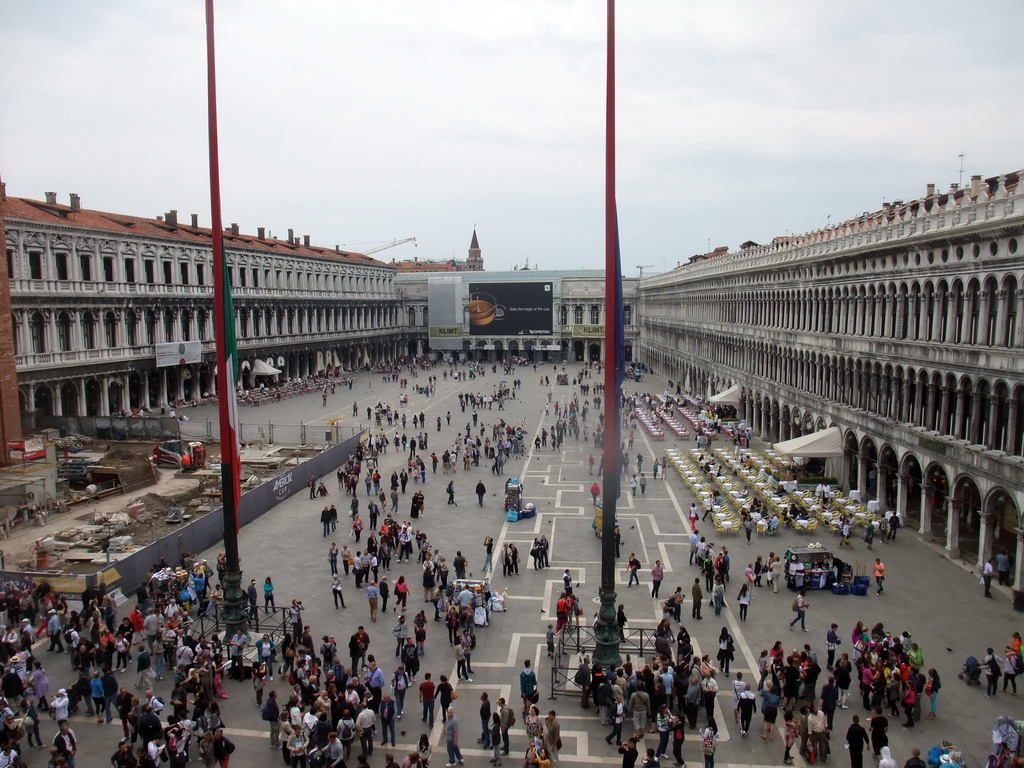 Venetian, Italian and European flags and the Piazza San Marco square with the Procuratie Nuove building, the Napoleonic Wing of the Procuraties building and the Procuratie Vecchie building, viewed from the loggia of the Basilica di San Marco church