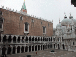 The Courtyard of the Palazzo Ducale palace with two wells, the west building, the Orologio clock, the south side of the Arco Foscari arch and the domes of the Basilica di San Marco church