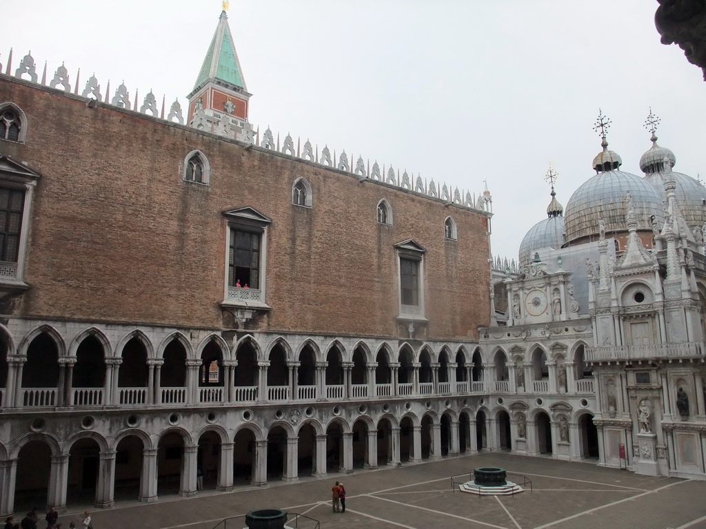 The Courtyard of the Palazzo Ducale palace with two wells, the west building, the Orologio clock, the south side of the Arco Foscari arch and the domes of the Basilica di San Marco church