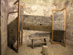 Chair, table and stone tablets in a cell at the Prigioni Nuove prison