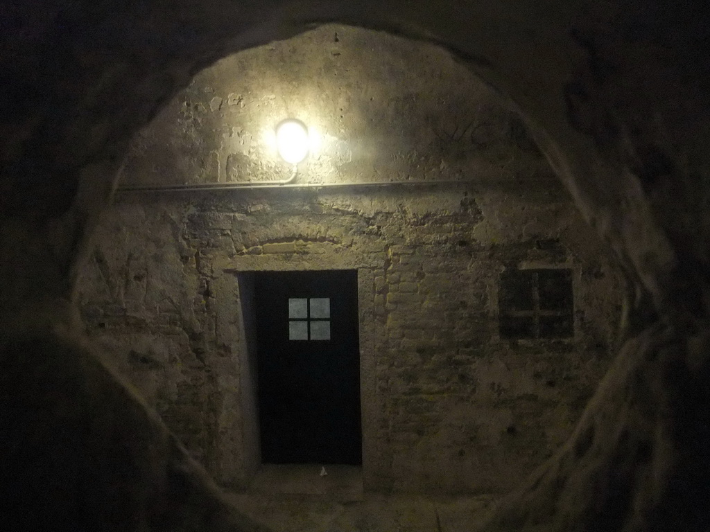 Door and window of a cell at the Prigioni Nuove prison, viewed through a hole in the wall