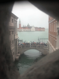 The Ponte della Paglia bridge over the Rio de Palazzo o de Canonica canal, the Bacino di San Marco basin and the Basilica di San Giorgio Maggiore church, viewed from a grated window in the Ponte dei Sospiri bridge