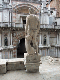 Back side of the right statue at the Scala dei Giganti staircase and the Arco Foscari arch at the Palazzo Ducale palace