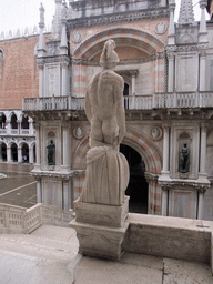 Back side of the left statue at the Scala dei Giganti staircase and the Arco Foscari arch at the Palazzo Ducale palace