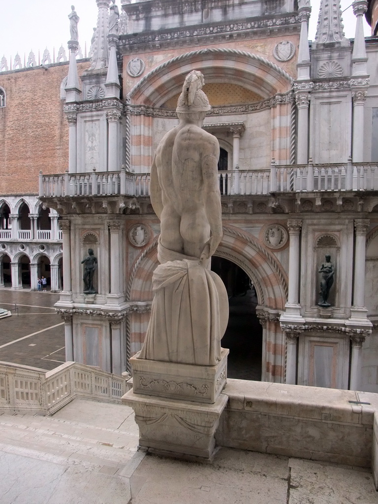 Back side of the left statue at the Scala dei Giganti staircase and the Arco Foscari arch at the Palazzo Ducale palace