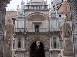 Back side of the left and right statue at the Scala dei Giganti staircase and the Arco Foscari arch at the Palazzo Ducale palace