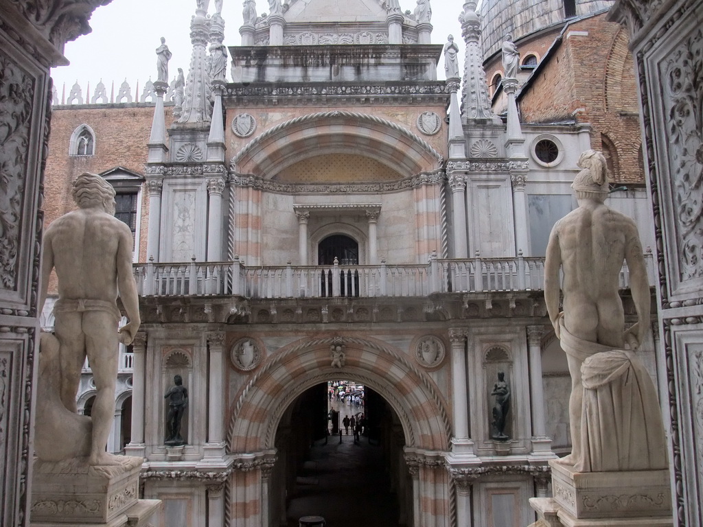 Back side of the left and right statue at the Scala dei Giganti staircase and the Arco Foscari arch at the Palazzo Ducale palace