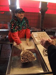 Merchant selling snails at the fish market at the Mercato del Pesce al Minuto building