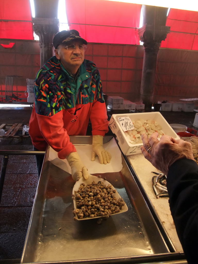 Merchant selling snails at the fish market at the Mercato del Pesce al Minuto building