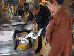 Merchant selling small fish at the fish market at the Calle Beccarie Cannaregio street